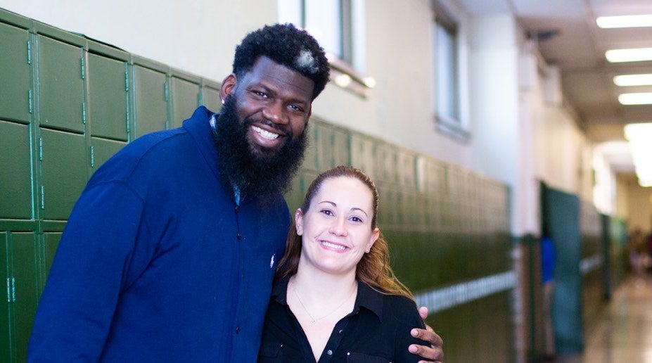 principal and teacher in a hallway